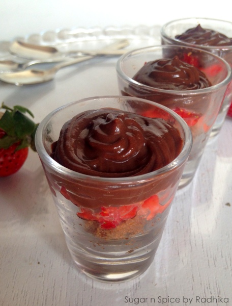 Chocolate pudding with brandy soaked plum cake and strawberries